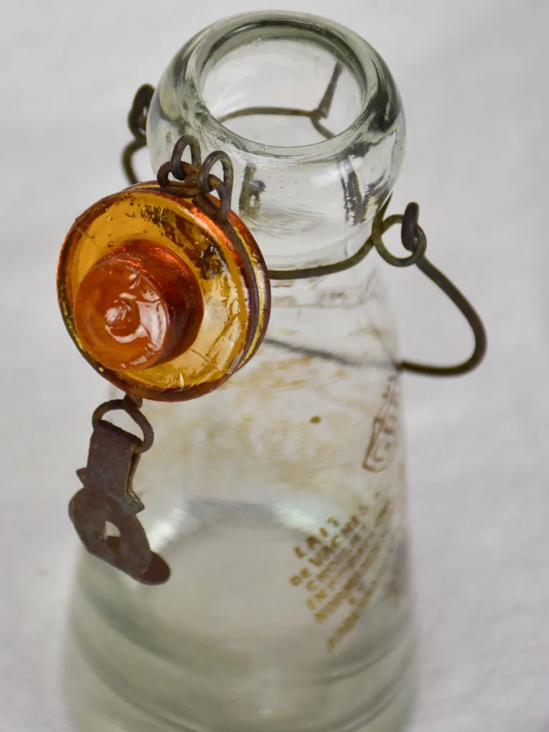 Antique French glass milk bottle with brown decoration