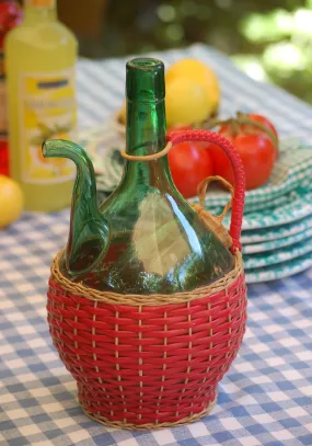 Vintage 1960s Italian emerald-green Empoli glass decanter with ice chamber. Red wicker decorated. Hand-blown in Tuscany.